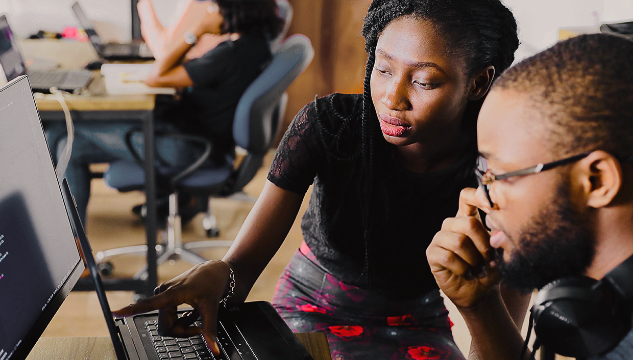 Two people working at a computer